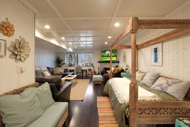 bedroom with coffered ceiling and dark wood-type flooring