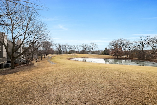 view of yard featuring a water view and central AC unit