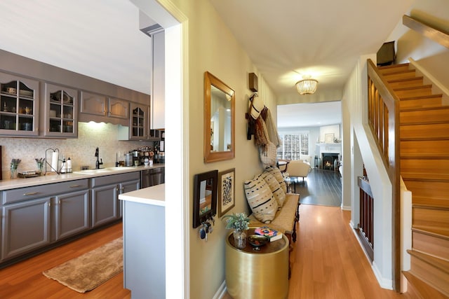 hall with sink and light hardwood / wood-style flooring