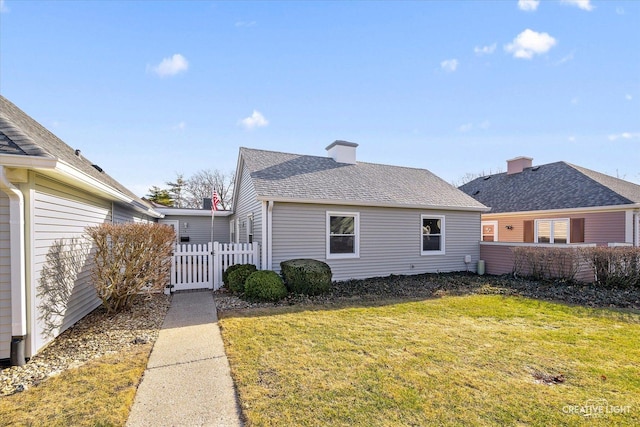 back of property featuring a lawn