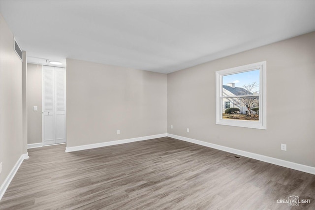 empty room with wood-type flooring