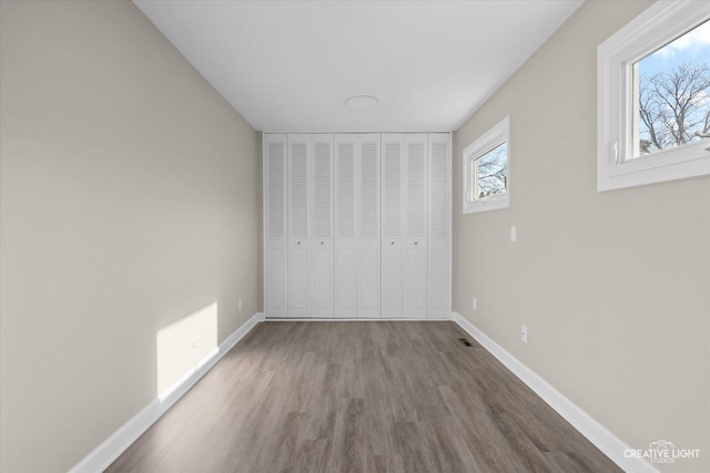 unfurnished bedroom with hardwood / wood-style floors