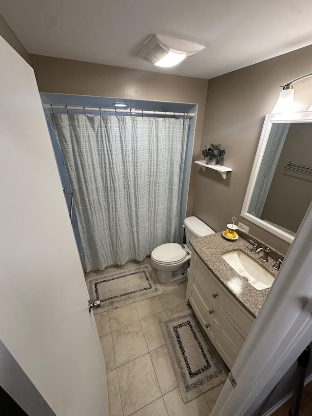 bathroom with tile patterned flooring, vanity, a shower with shower curtain, and toilet