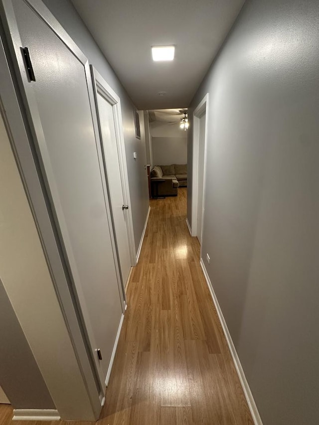 corridor with light hardwood / wood-style flooring