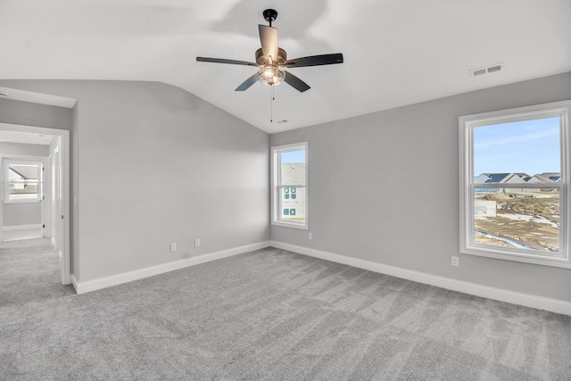 unfurnished room featuring ceiling fan, lofted ceiling, and light carpet