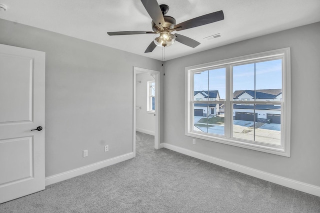 carpeted empty room featuring ceiling fan