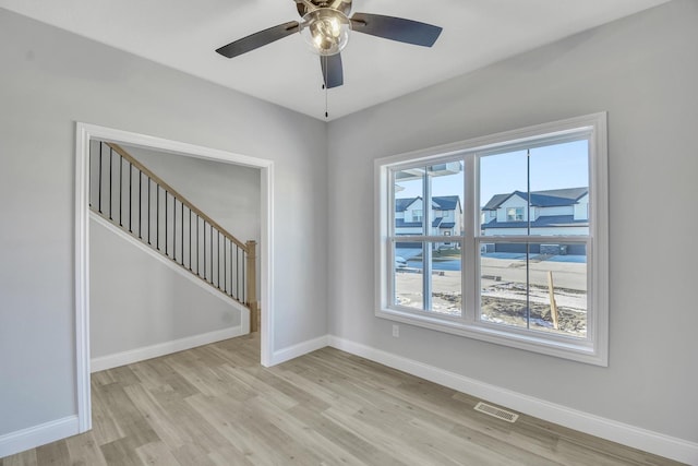 empty room with light hardwood / wood-style floors and ceiling fan