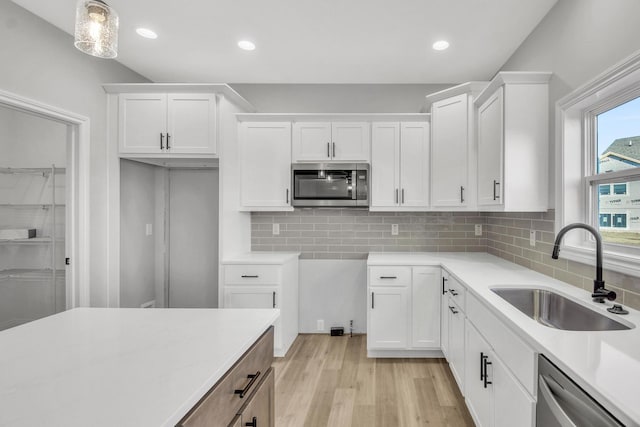 kitchen featuring white cabinetry, stainless steel appliances, and sink