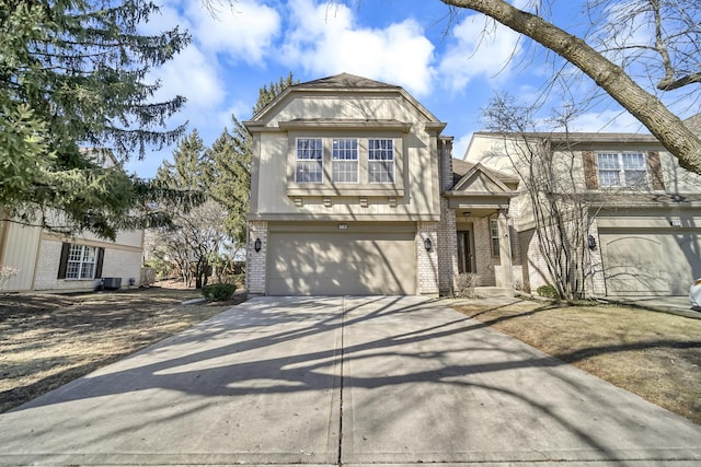 view of front facade with brick siding, an attached garage, and driveway