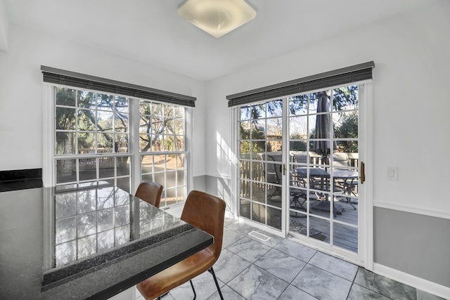 dining room with baseboards and marble finish floor