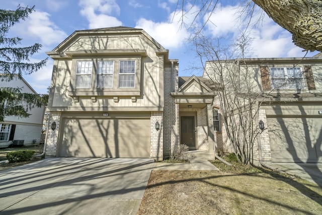 view of front of home with a garage, brick siding, and driveway