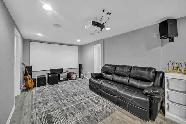 cinema featuring recessed lighting, wood finished floors, and baseboards