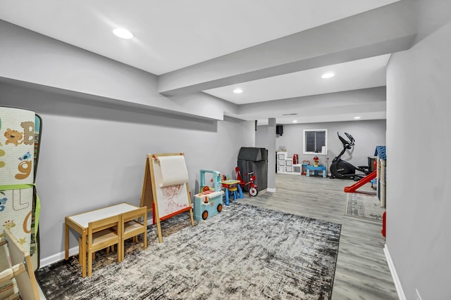 recreation room with recessed lighting, baseboards, and wood finished floors