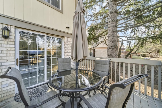 wooden terrace with outdoor dining area