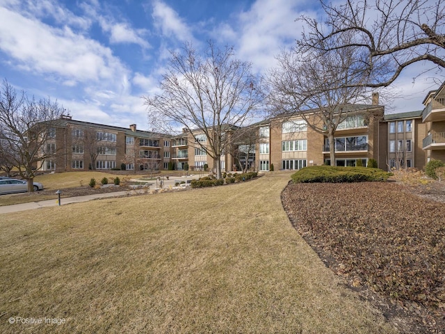 view of home's community featuring a lawn