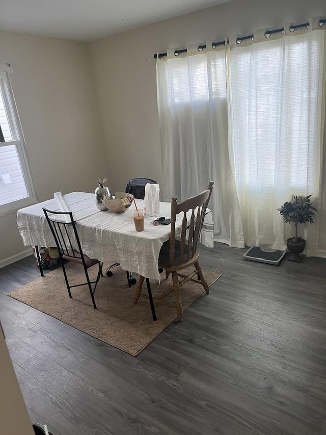 dining area with dark hardwood / wood-style floors