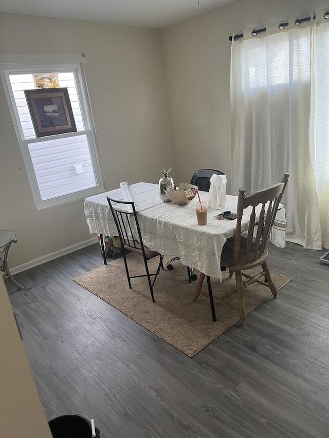 dining area with dark wood-type flooring