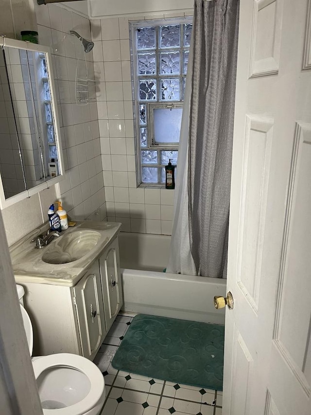 full bathroom with vanity, shower / bathtub combination with curtain, and toilet