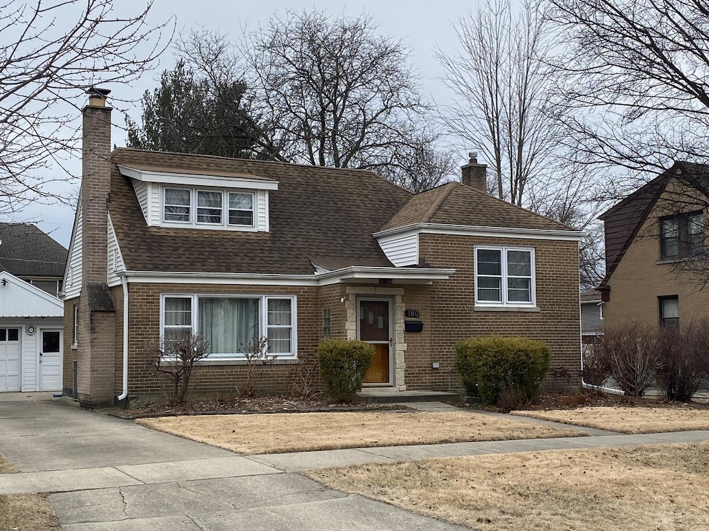 view of front of home featuring a garage and an outdoor structure