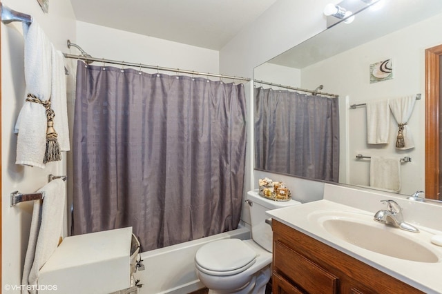 bathroom featuring toilet, shower / bath combo with shower curtain, and vanity