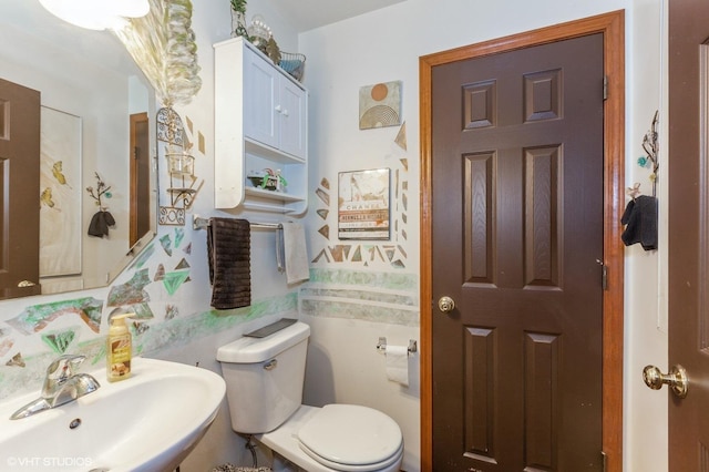 bathroom with toilet and a sink