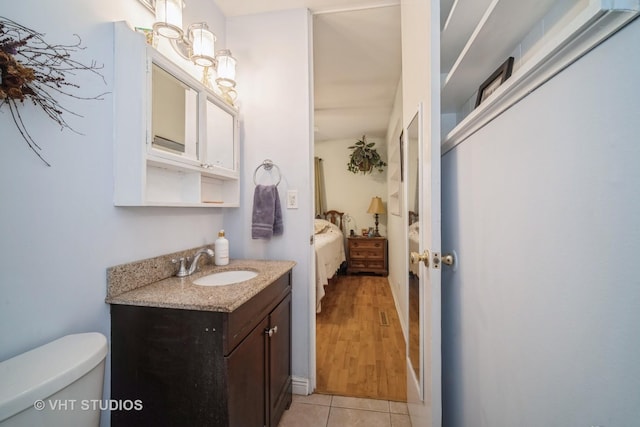 bathroom with vanity, tile patterned floors, and toilet