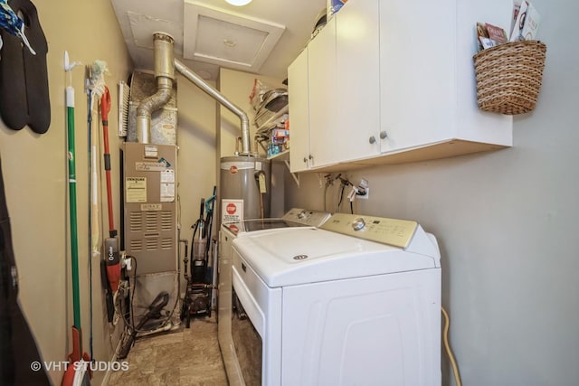 laundry area with cabinets, washing machine and dryer, and gas water heater