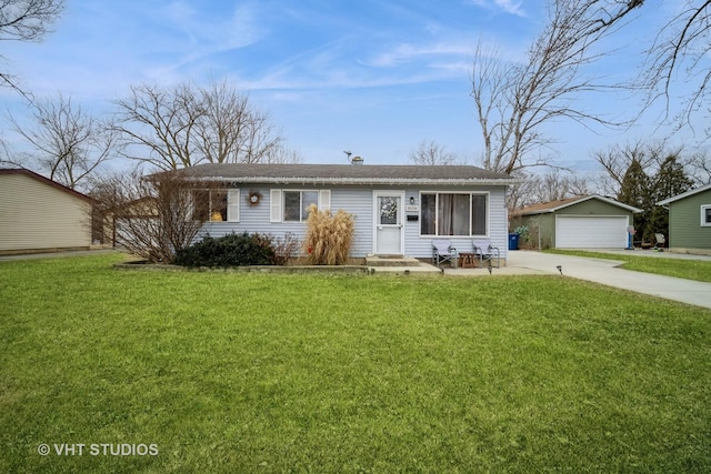 ranch-style house featuring an outbuilding, a garage, and a front lawn