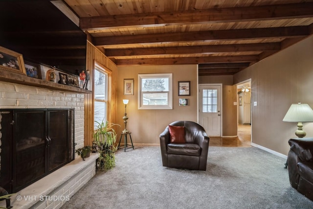 living room with beamed ceiling, carpet flooring, wood ceiling, and a fireplace