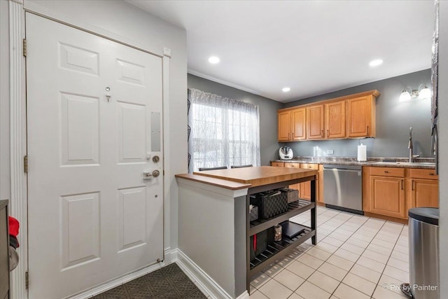 kitchen featuring light tile patterned flooring, stainless steel dishwasher, and sink