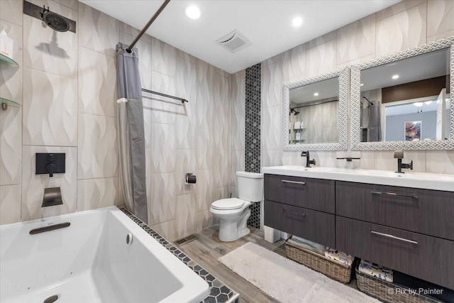 full bathroom with shower / bath combination with curtain, vanity, toilet, and tile walls