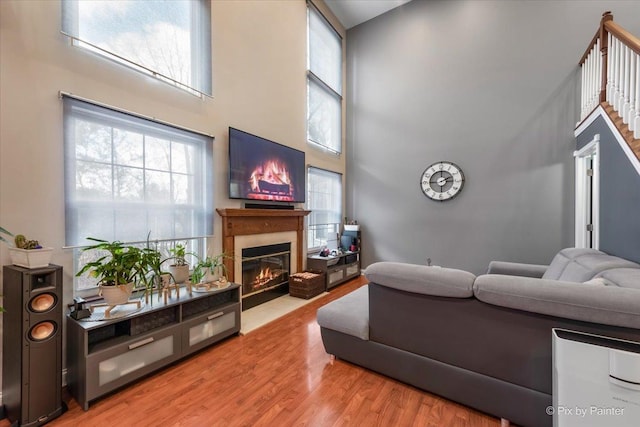 living room with hardwood / wood-style floors and a high ceiling