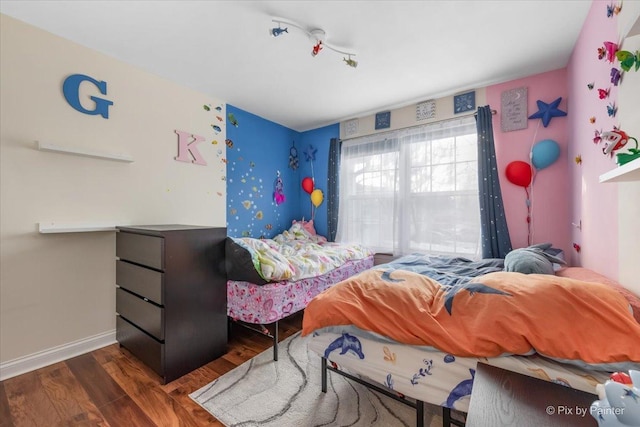 bedroom with dark hardwood / wood-style flooring