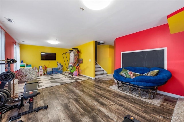 workout area with hardwood / wood-style floors