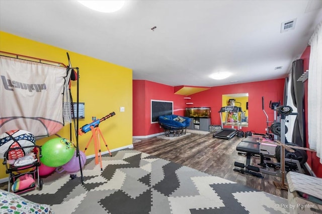 exercise area featuring hardwood / wood-style flooring