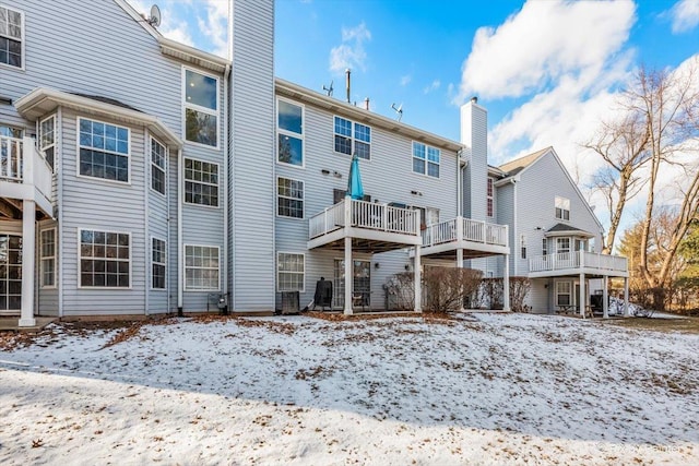 view of snow covered rear of property