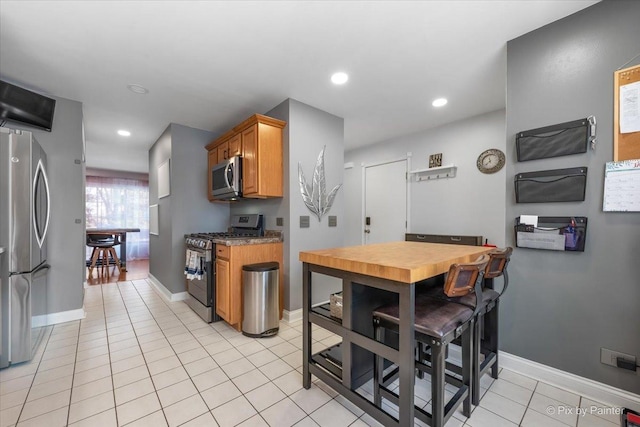 kitchen featuring light tile patterned flooring and appliances with stainless steel finishes