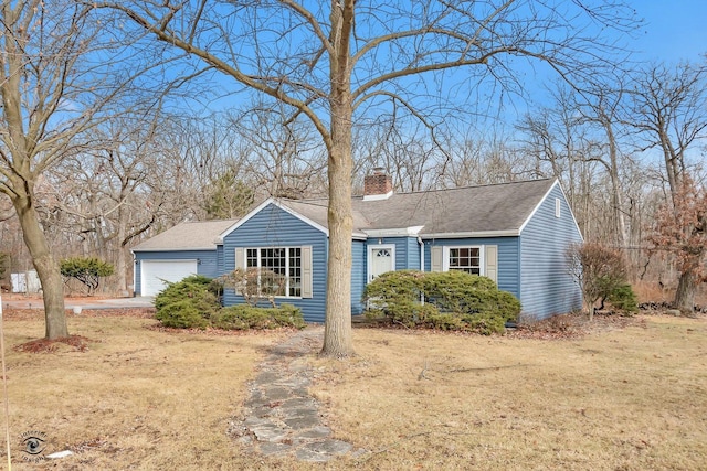 ranch-style house featuring a garage and a front yard