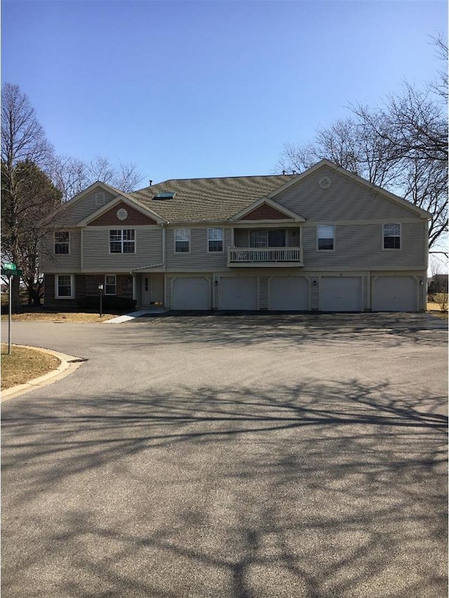 view of front of property featuring aphalt driveway and an attached garage