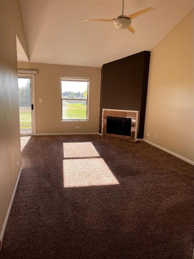 unfurnished living room with lofted ceiling, carpet flooring, a fireplace, and baseboards