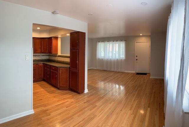 kitchen with tasteful backsplash and light hardwood / wood-style floors