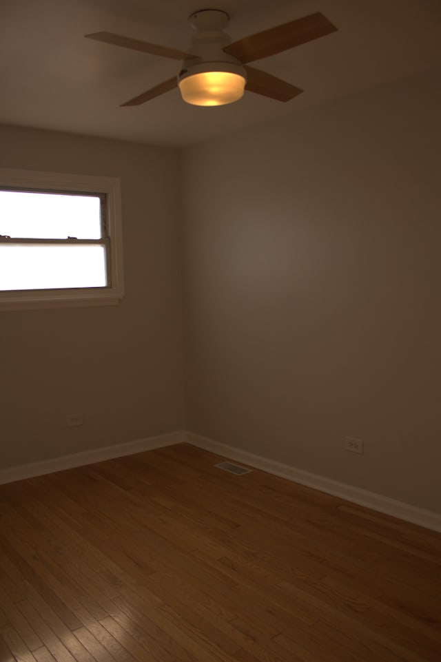 unfurnished room featuring hardwood / wood-style floors and ceiling fan