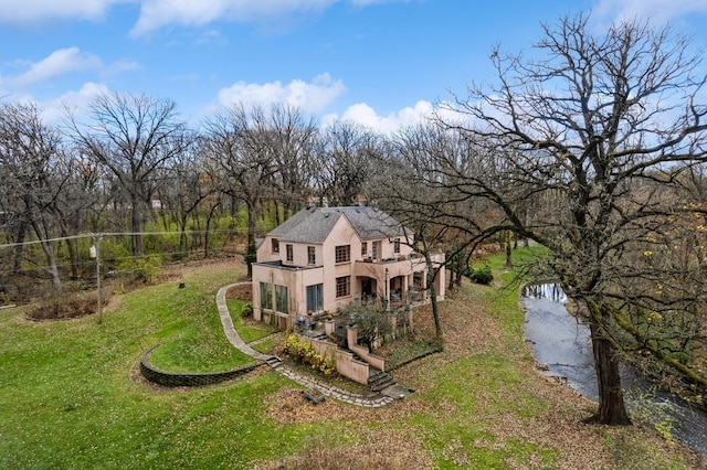 exterior space featuring a water view and a yard