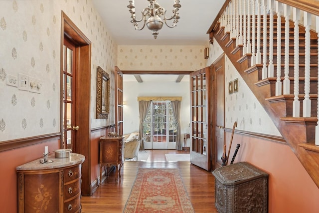 entryway featuring wood-type flooring and a chandelier