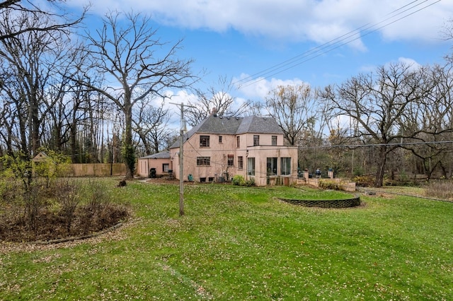 back of house with a lawn