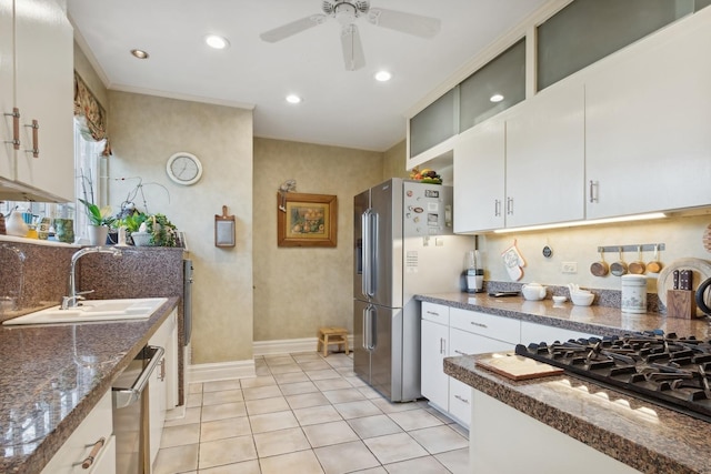 kitchen with sink, light tile patterned flooring, white cabinets, and appliances with stainless steel finishes