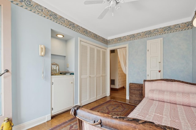 bedroom featuring a closet, ceiling fan, and light hardwood / wood-style flooring