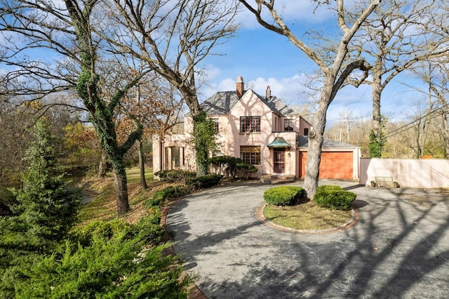 tudor-style house featuring a garage