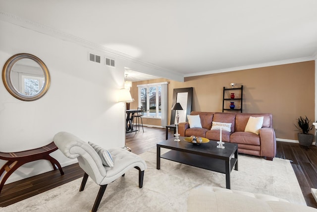 living room with hardwood / wood-style flooring and crown molding