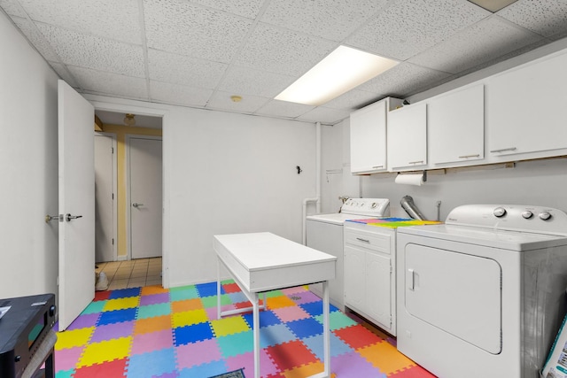 laundry room featuring washing machine and dryer and cabinets